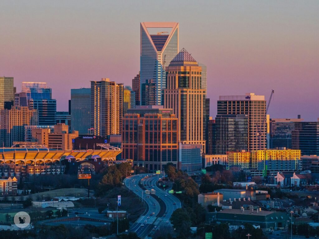 A stunning view of Charlotte's modern skyline at sunset, highlighting skyscrapers and urban design.