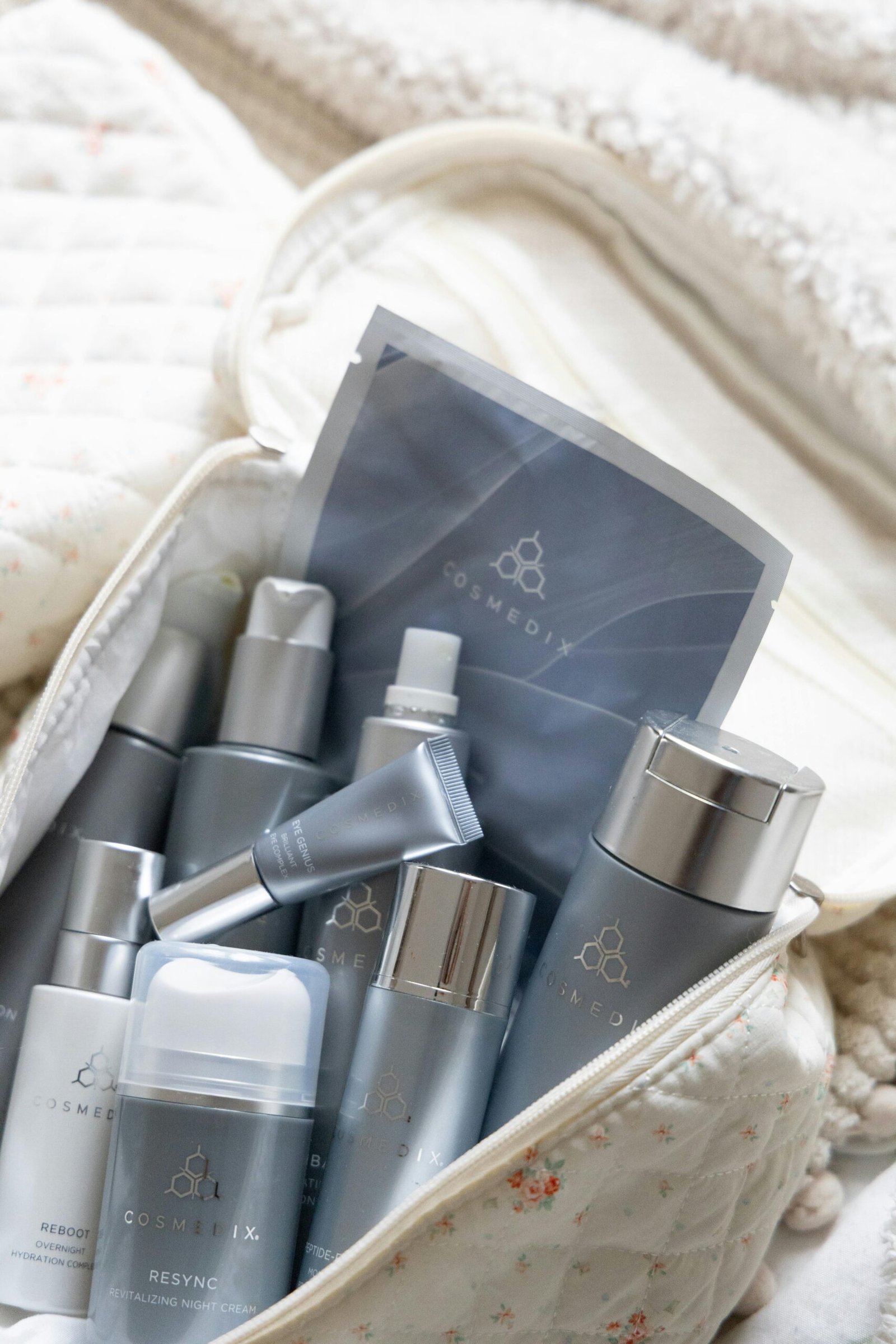 Home A selection of skincare products neatly arranged in a quilted travel bag for easy access.