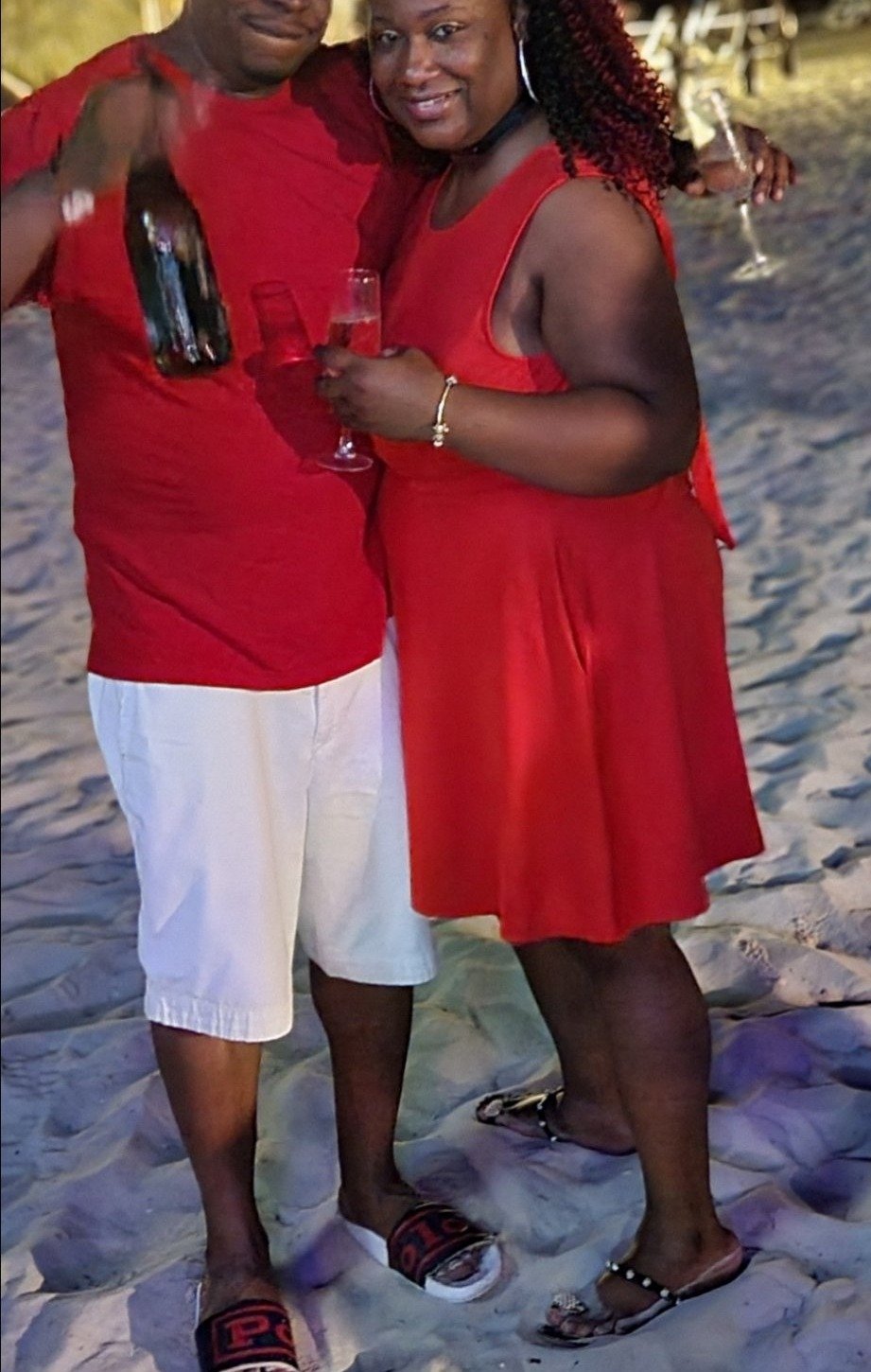 Ron and Tee in red on the beach at night